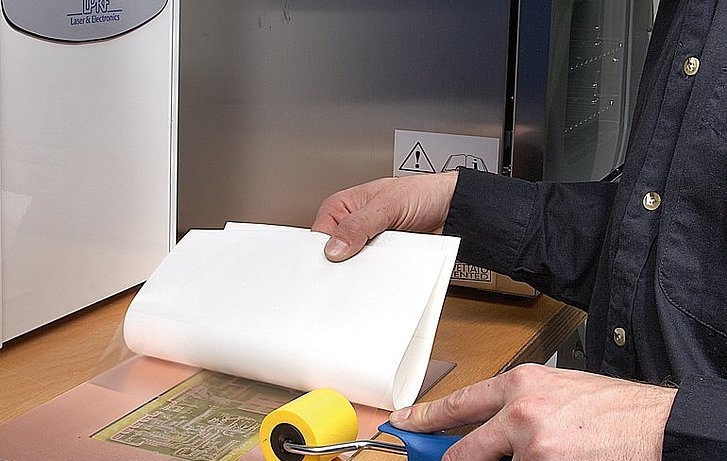 Applying the protective foil and drilling the through holes